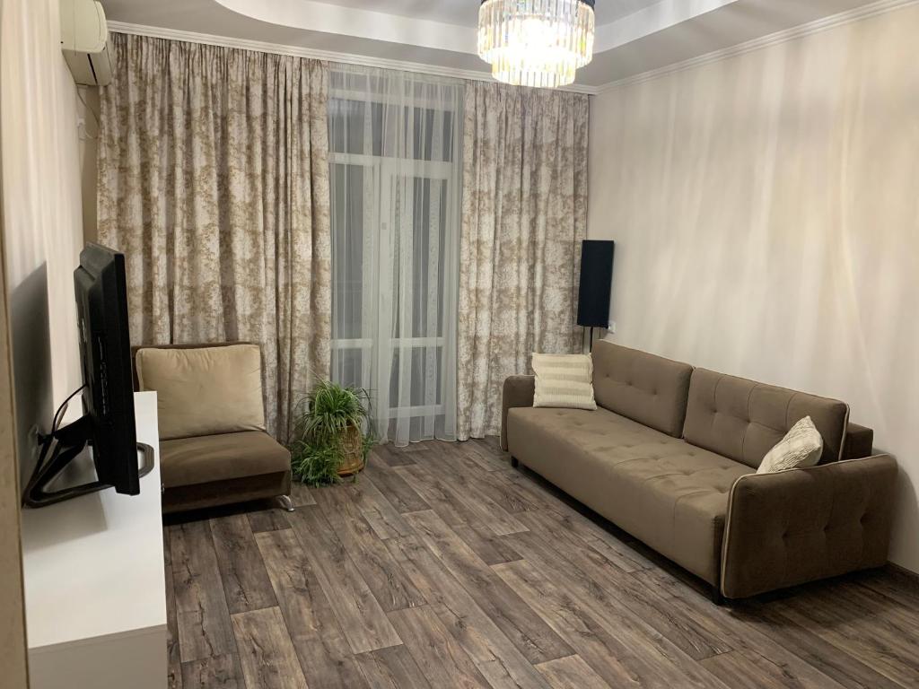 a living room with a couch and a tv at 2-комнатная квартира на Соборной in Mykolaiv