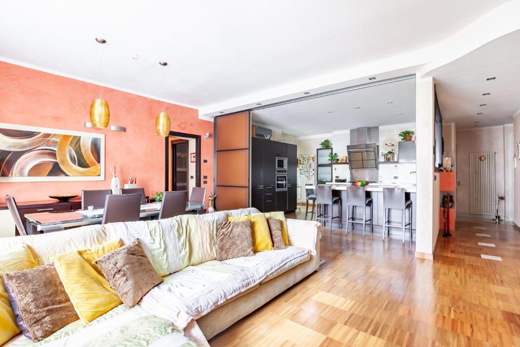 uma sala de estar com um sofá branco e uma cozinha em Beatrice Apartment em Massa
