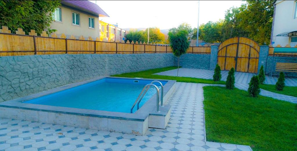 una piscina en un patio al lado de una casa en Green Garden Garni, en Garni
