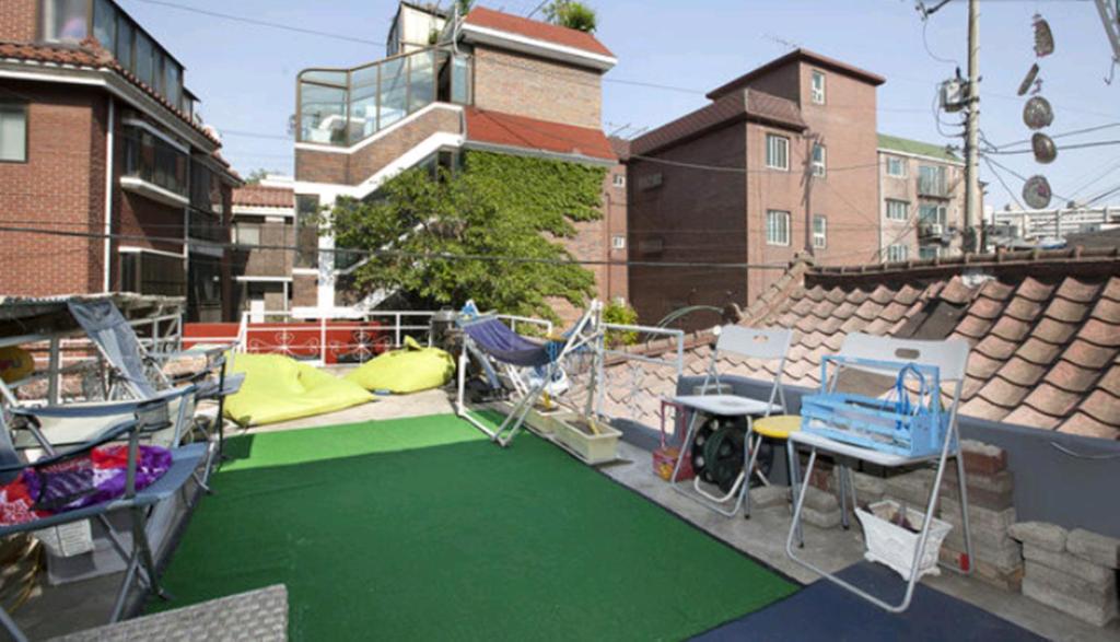 a patio with a playground with chairs and a table at Noel's Guesthouse in Seoul