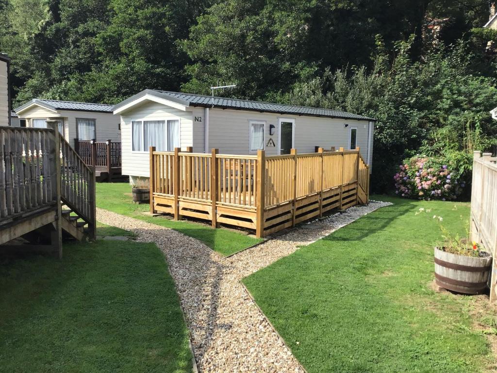 a wooden fence in a yard with a house at Peaceful Paradise in Ilfracombe