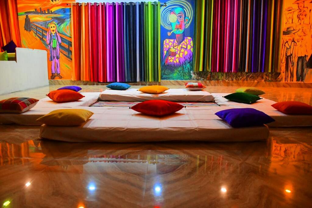 a large bed with colorful pillows in a room at Gypsy Diaries Varanasi in Varanasi