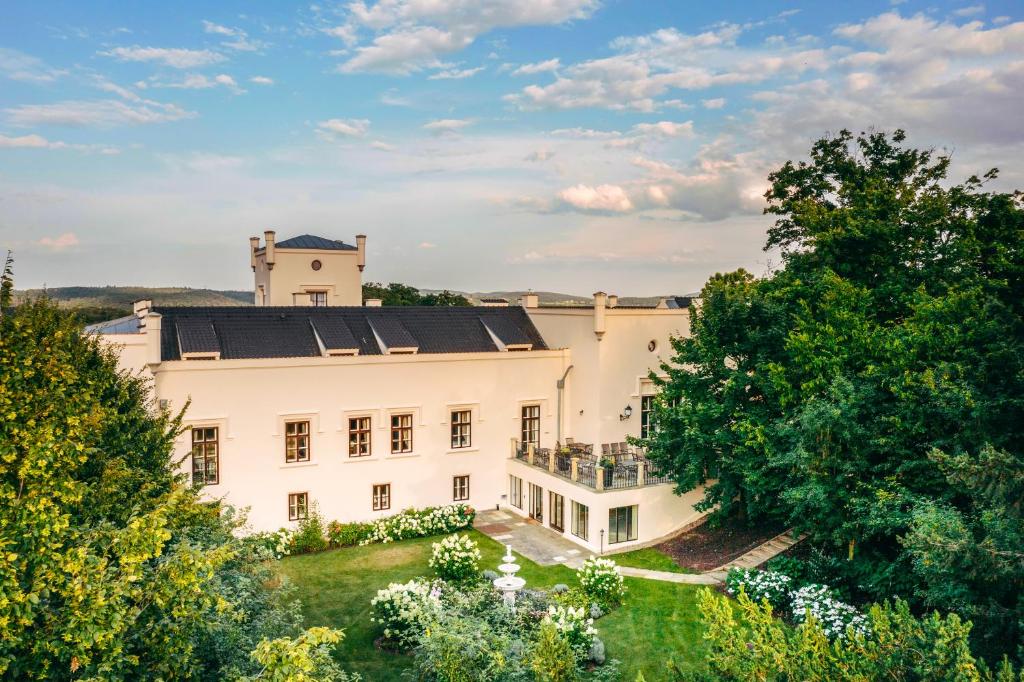 an aerial view of a large white house with trees at Hotel & Restaurant Chateau Trnová in Trnowa