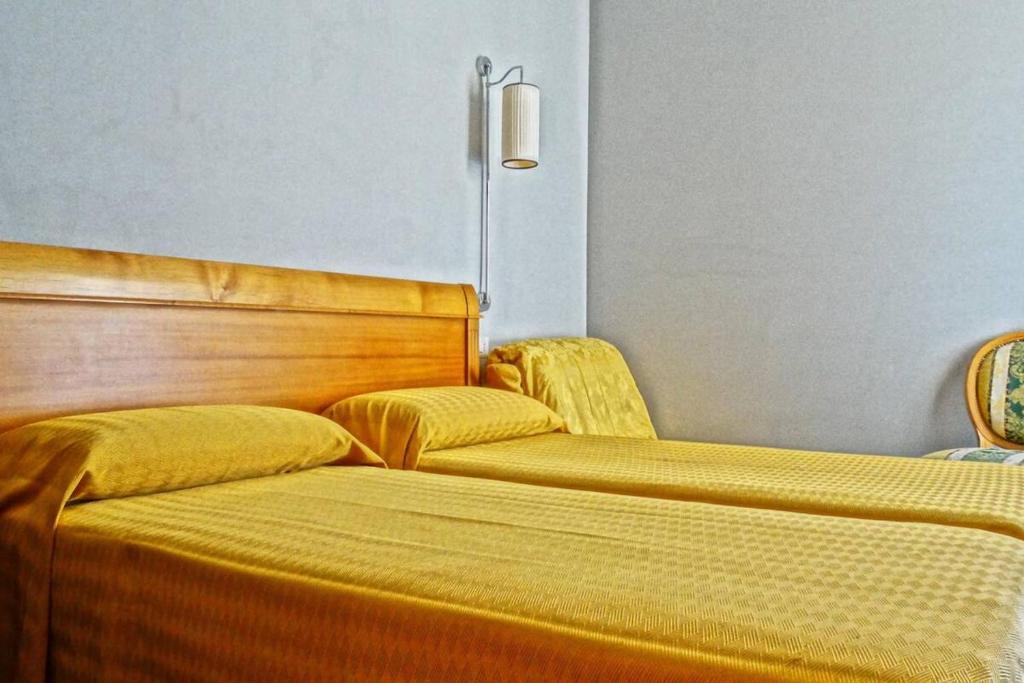 Postel nebo postele na pokoji v ubytování Hotel dei Quiriti