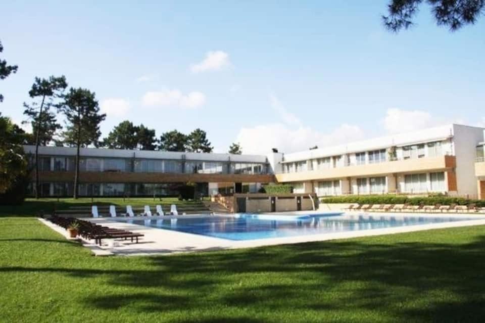 a large building with a pool in front of a building at Barca House - Nature - Golf - Pool & Beach in Esposende