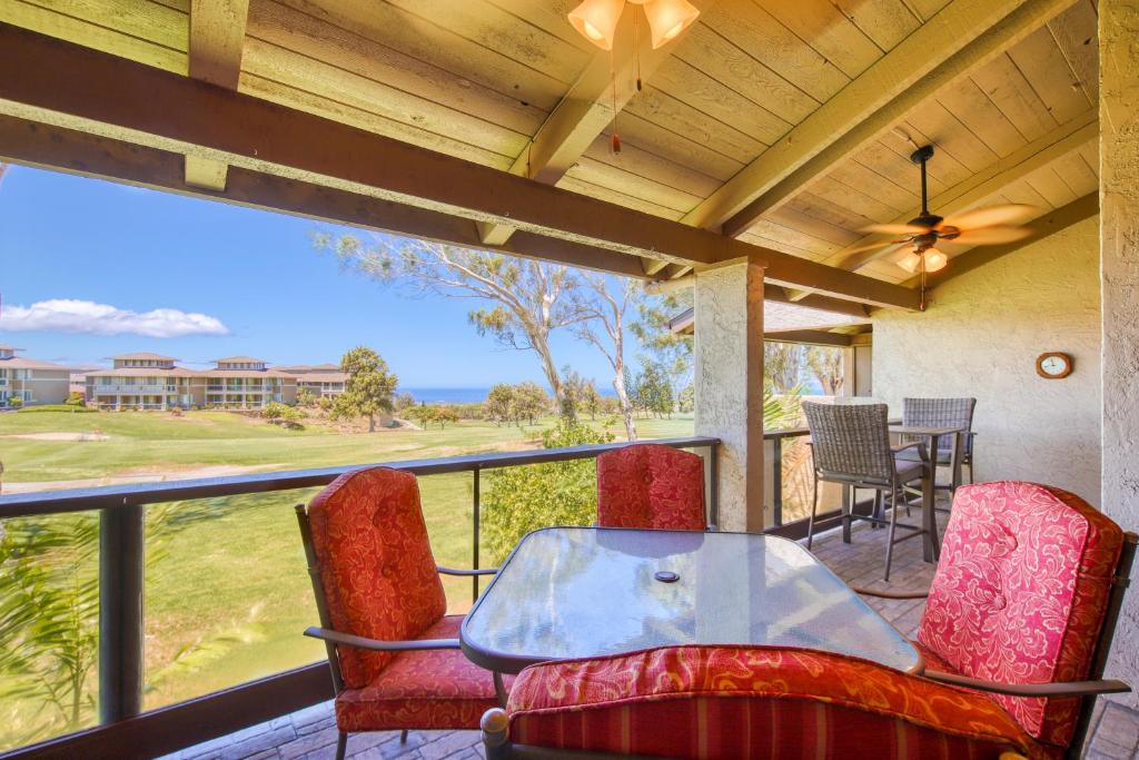 a patio with a table and chairs on a balcony at Villas at Waikoloa H203 in Waikoloa Village