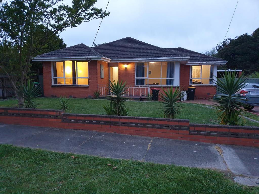 a house with a brick fence in front of it at Homestay near Dandenong Plaza in Dandenong