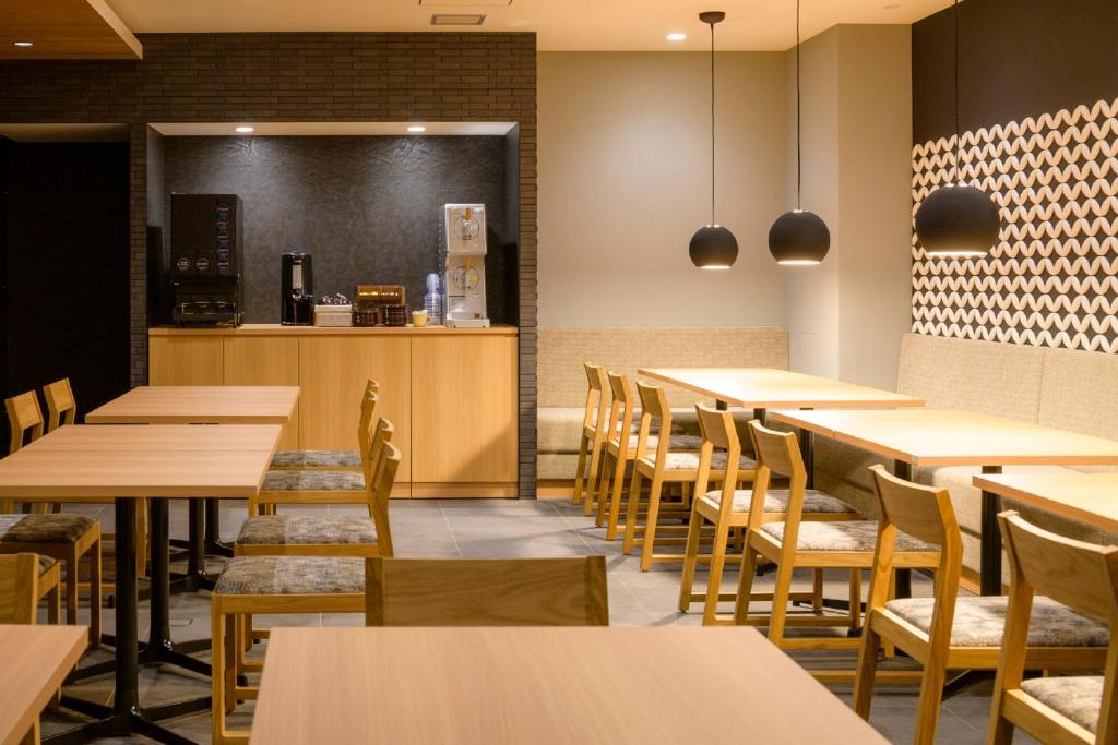 a restaurant with tables and chairs and a counter at Tosei Hotel Cocone Kamakura in Kamakura