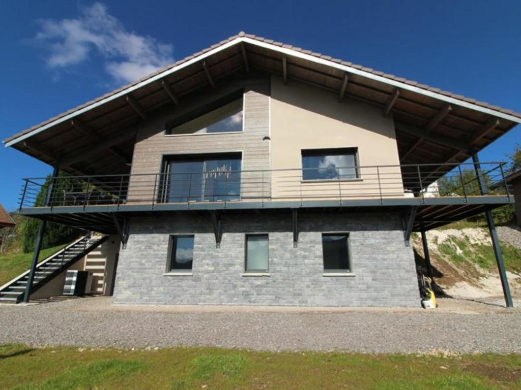 a house with a balcony on top of it at Gîte La Bresse, 5 pièces, 8 personnes - FR-1-589-385 in La Bresse