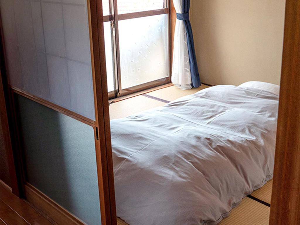 Postel nebo postele na pokoji v ubytování Yukinoura Guest House Moritaya