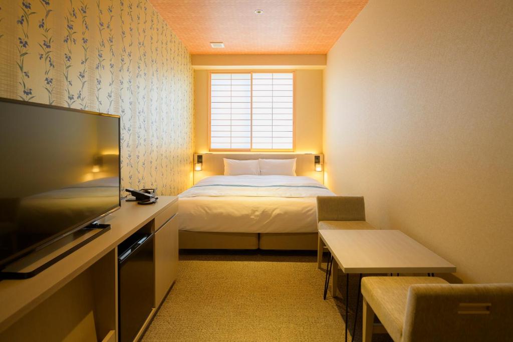 a hotel room with a bed and a television at Tosei Hotel Cocone Kamakura in Kamakura