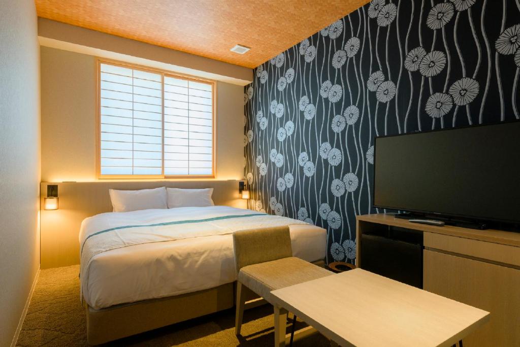 a hotel room with a bed and a television at Tosei Hotel Cocone Kamakura in Kamakura