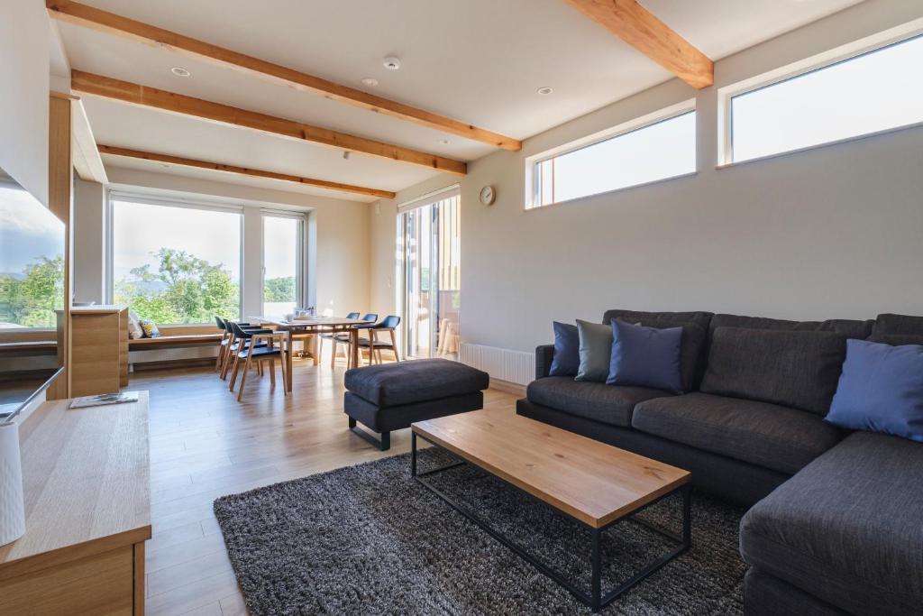 a living room with a couch and a table at Furano Sanso in Furano