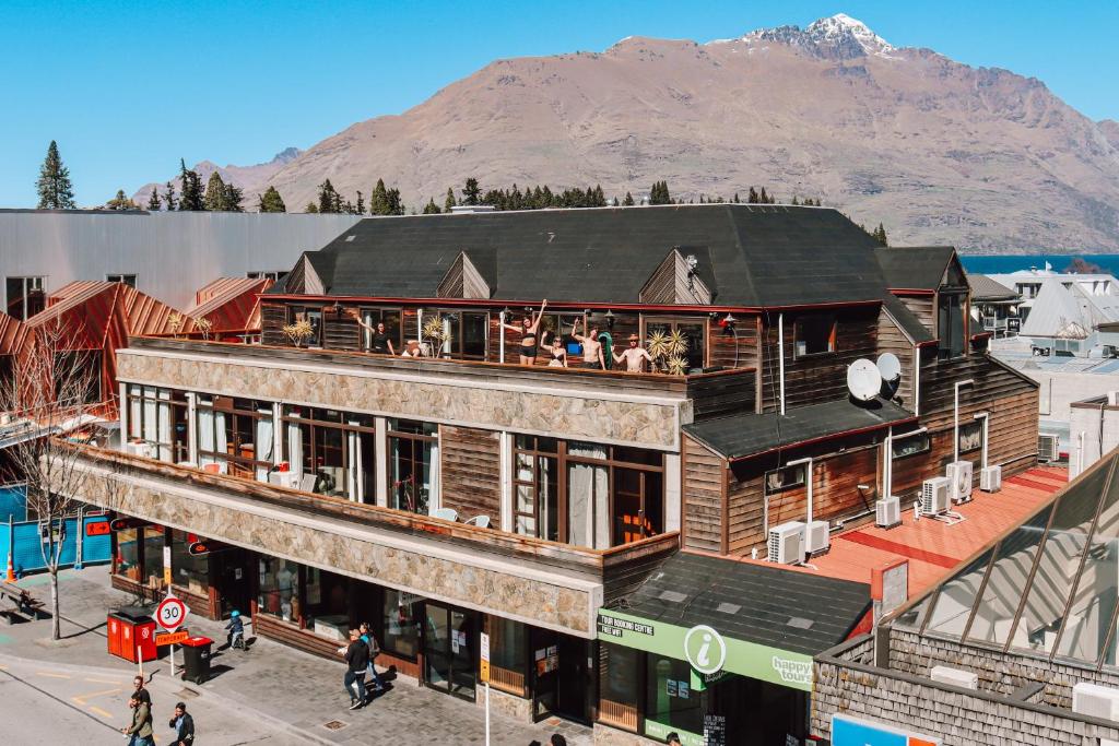 a large building with a lot of windows on top of it at Adventure Queenstown Hostel in Queenstown