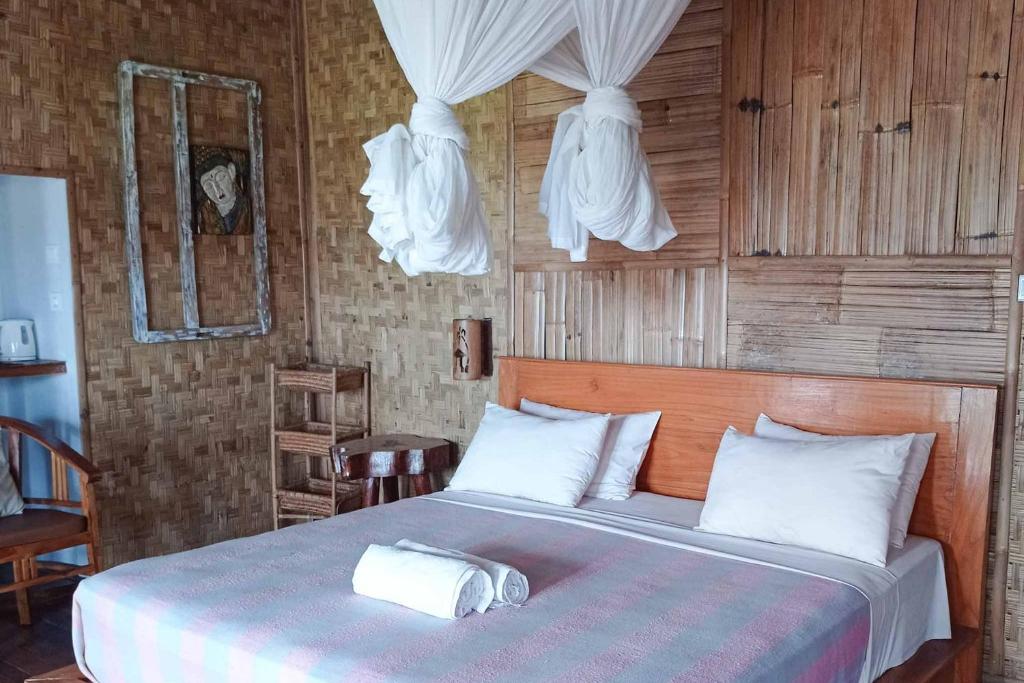 Postel nebo postele na pokoji v ubytování Jepun Didulu Cottages