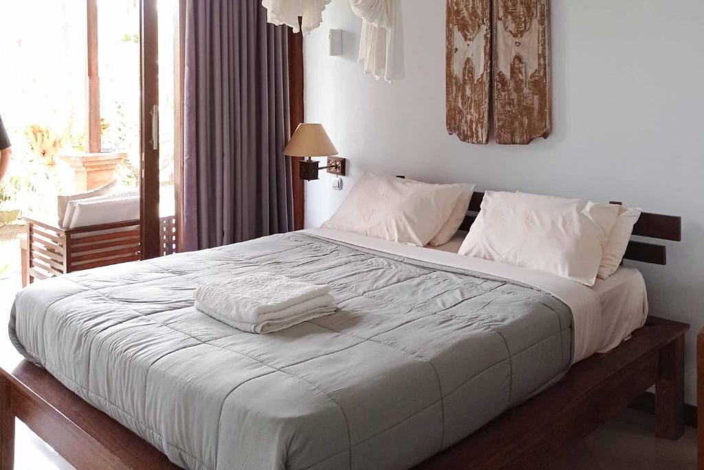 Postel nebo postele na pokoji v ubytování Jepun Didulu Cottages