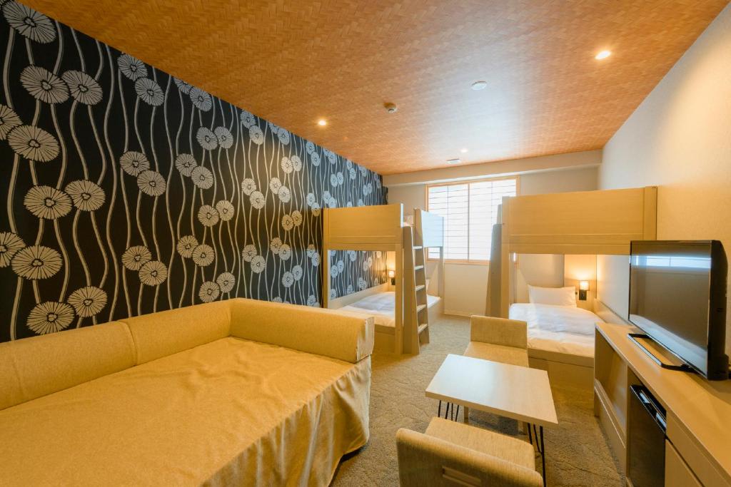 a room with a couch and a tv and a bedroom at Tosei Hotel Cocone Kamakura in Kamakura