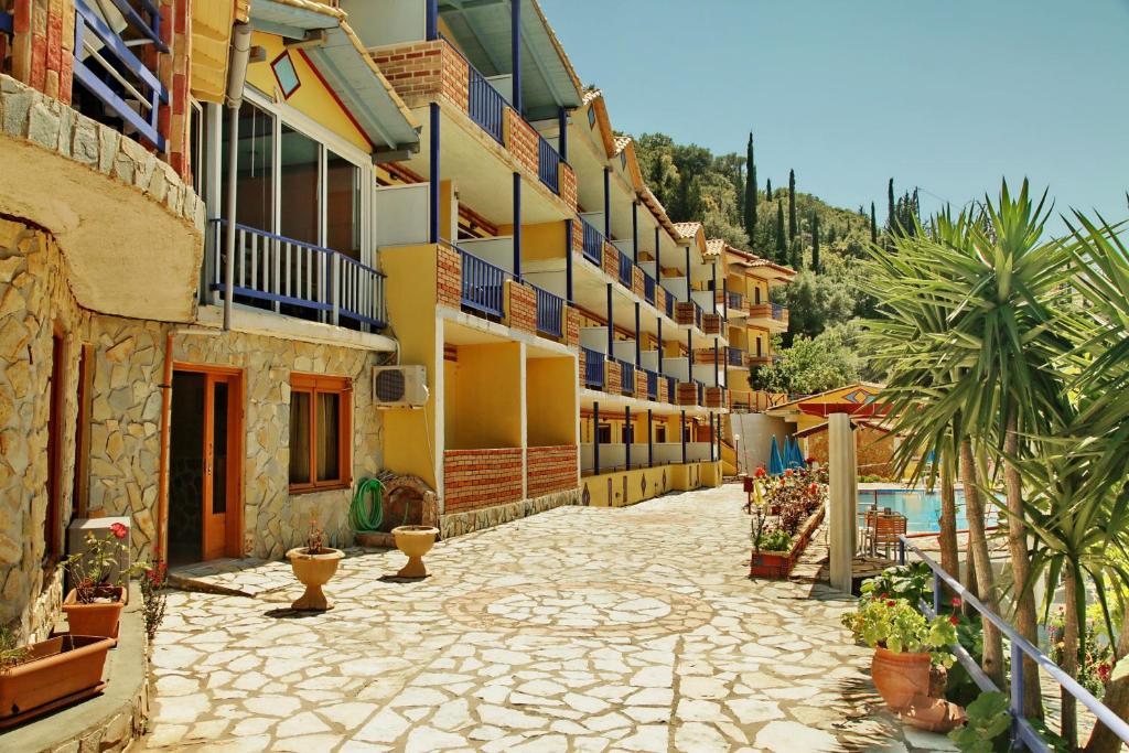a courtyard of a building with potted plants at Politia Hotel in Agios Nikitas