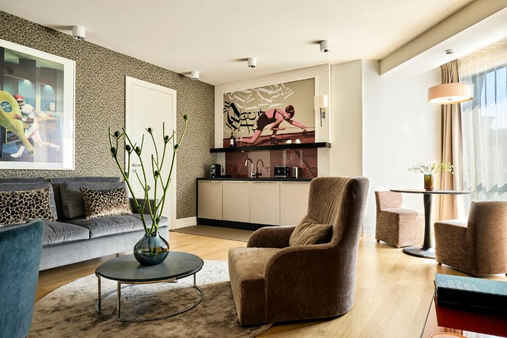 a living room with a couch and chairs and a table at H15 Boutique Hotel, Warsaw, a Member of Design Hotels in Warsaw