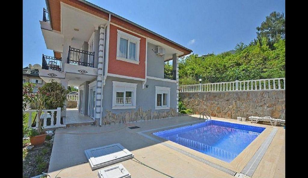 una casa con piscina frente a una casa en Villa Zehra Private Pool & Garden en Alanya