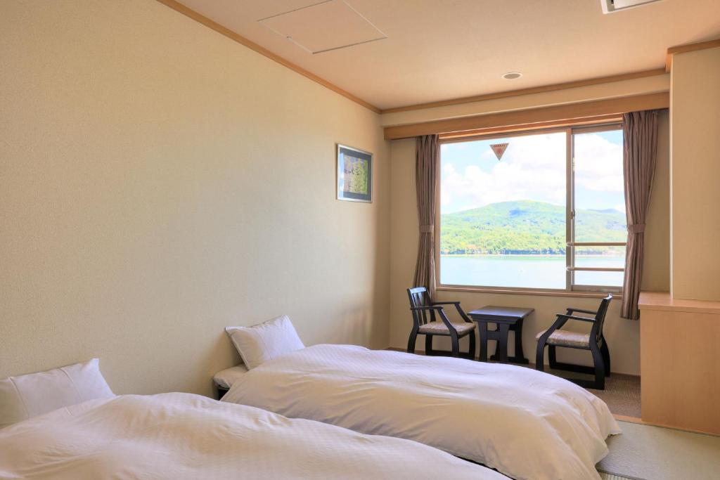 Postel nebo postele na pokoji v ubytování Fuji Matsuzono Hotel