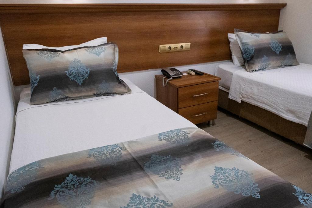 Postel nebo postele na pokoji v ubytování Kıspet Konak Hotel