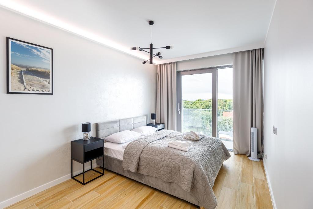 Posteľ alebo postele v izbe v ubytovaní Balticus Apartamenty Deluxe Promenada Gwiazd 14