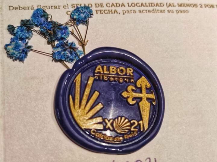 a blue and gold medal with a cross on it at Albergue Albor in Caldas de Reis