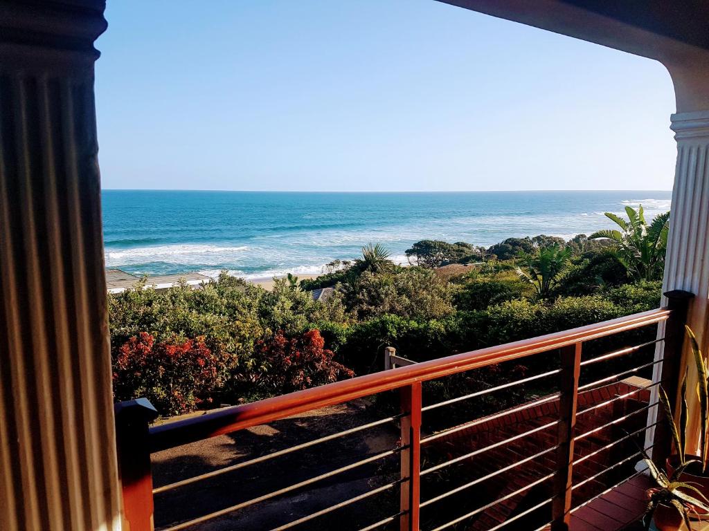 a balcony with a view of the ocean at Zinkwazi Beach townhouse in Zinkwazi Beach
