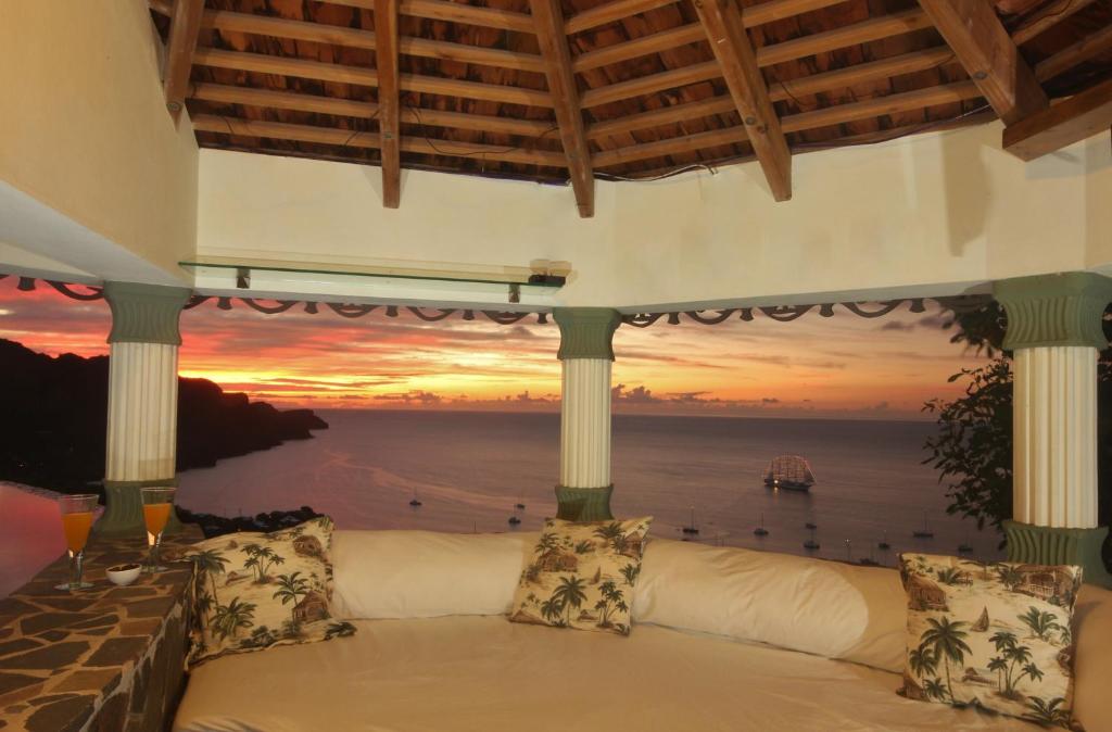 a room with a couch with a view of the ocean at Tropical Hideaway in Port Elizabeth