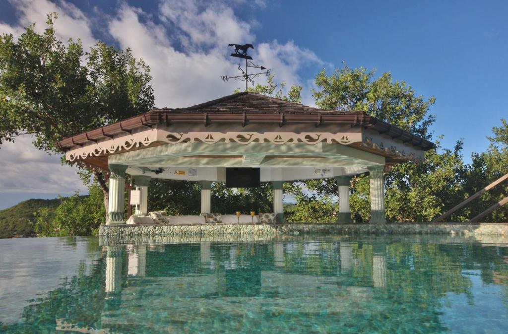 a gazebo next to a body of water at Tropical Hideaway in Port Elizabeth