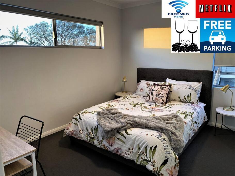 a bedroom with a bed and a window at Chic 2Bed Close Airport Shops NETFLIX WIFI WINE in Perth