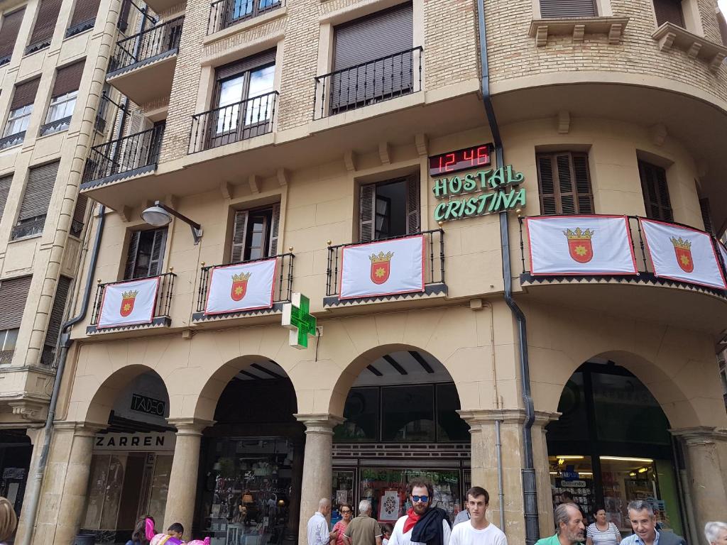 a large building with a sign on the side of it at Hostal Cristina in Estella