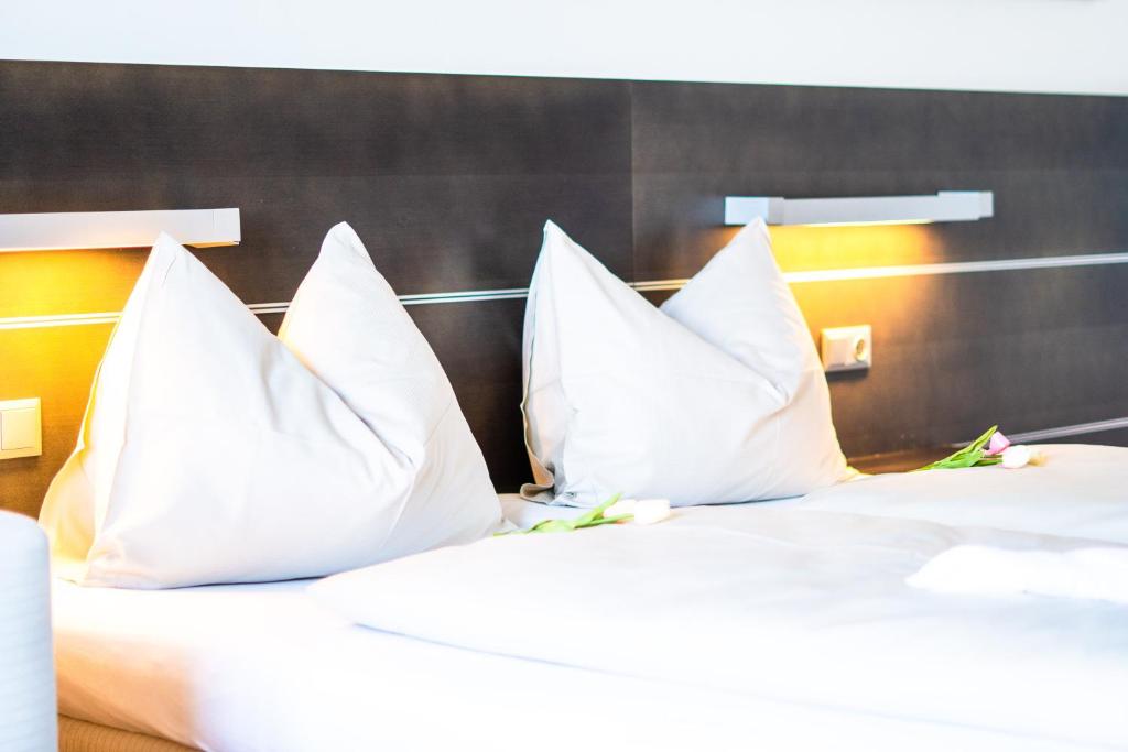 A bed or beds in a room at Neufeldersee Hotel & Restaurant