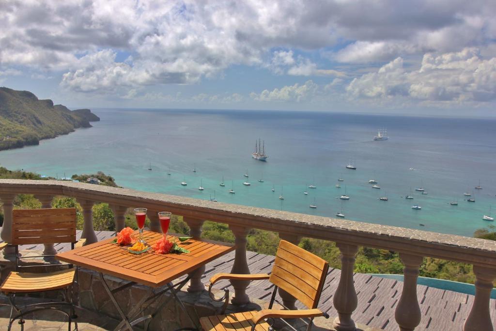 a table on a balcony with a view of the ocean at Tropical Hideaway in Port Elizabeth