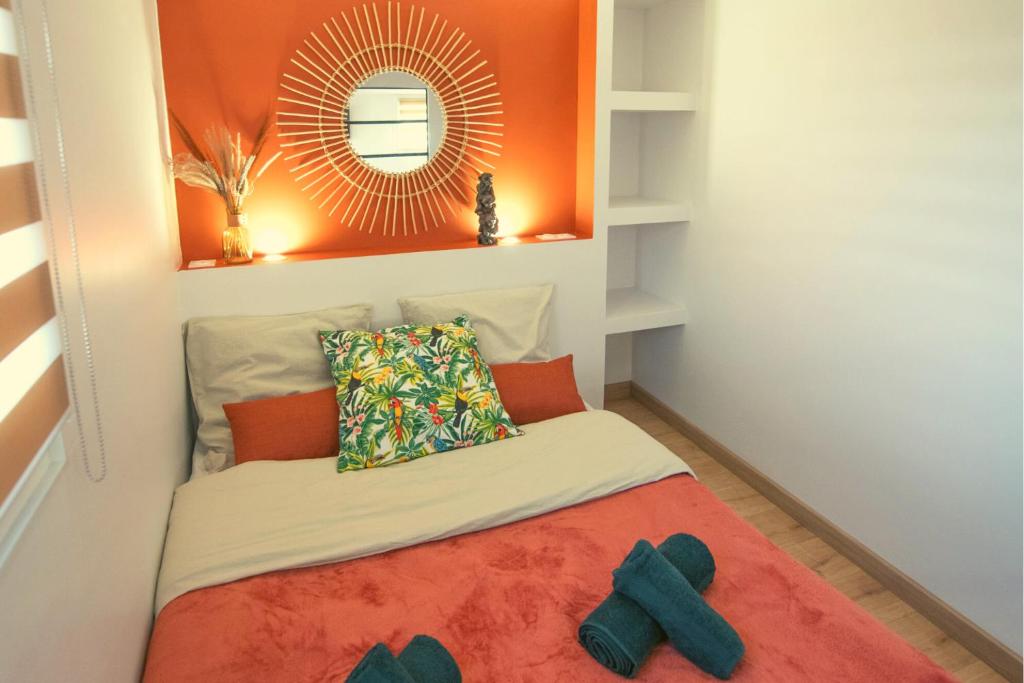 a small bed in a room with a mirror at KASA HOME - Calme, Cosy, WIFI &amp; Netflix in Saint-Martin-la-Plaine