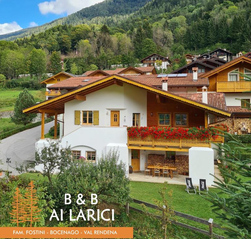 a house in a valley with a mountain at B&B Ai Larici in Bocenago