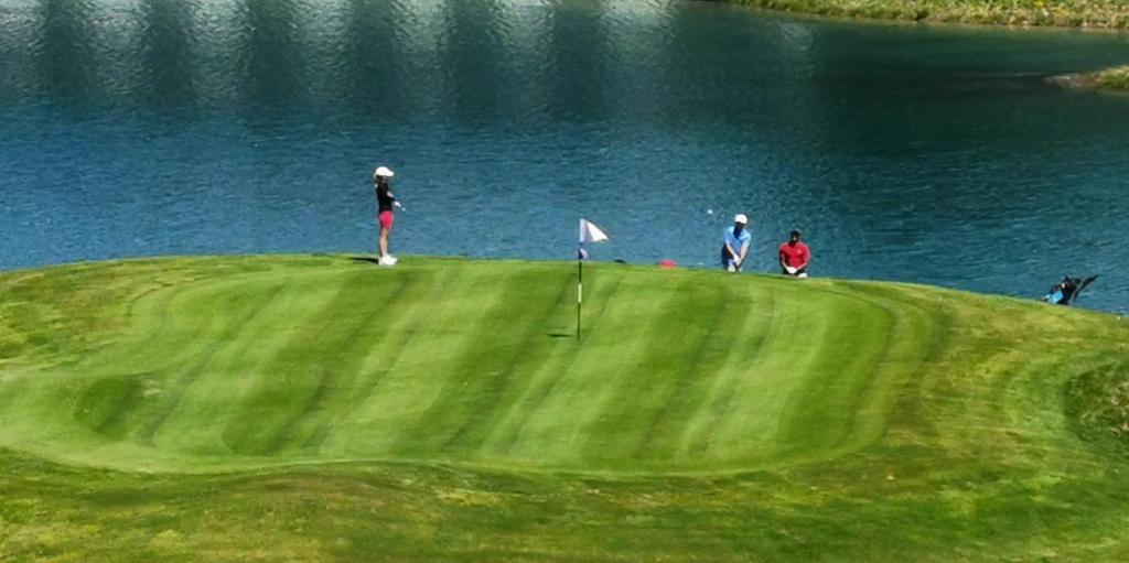 a group of people standing on top of a golf course at Chalet Emilie in Courchevel