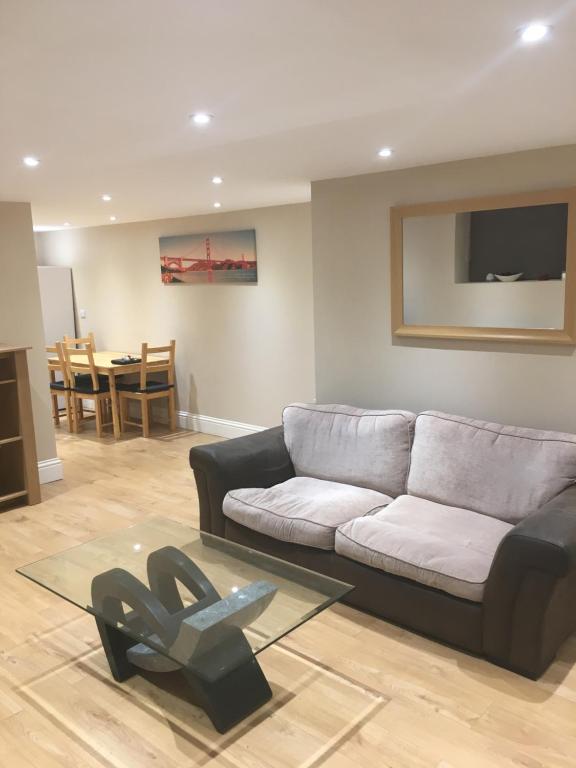 a living room with a couch and a table at RIVERSIDE APARTMENT IN THE CENTRE in Boston