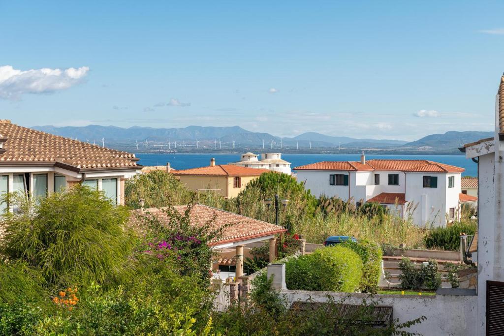 a city with houses and the water in the background at Casa Giovanna e Antonio in Calasetta