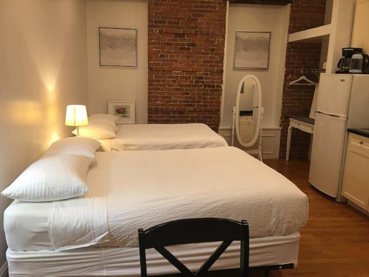 a bedroom with two beds and a refrigerator at Hansem stay in New York