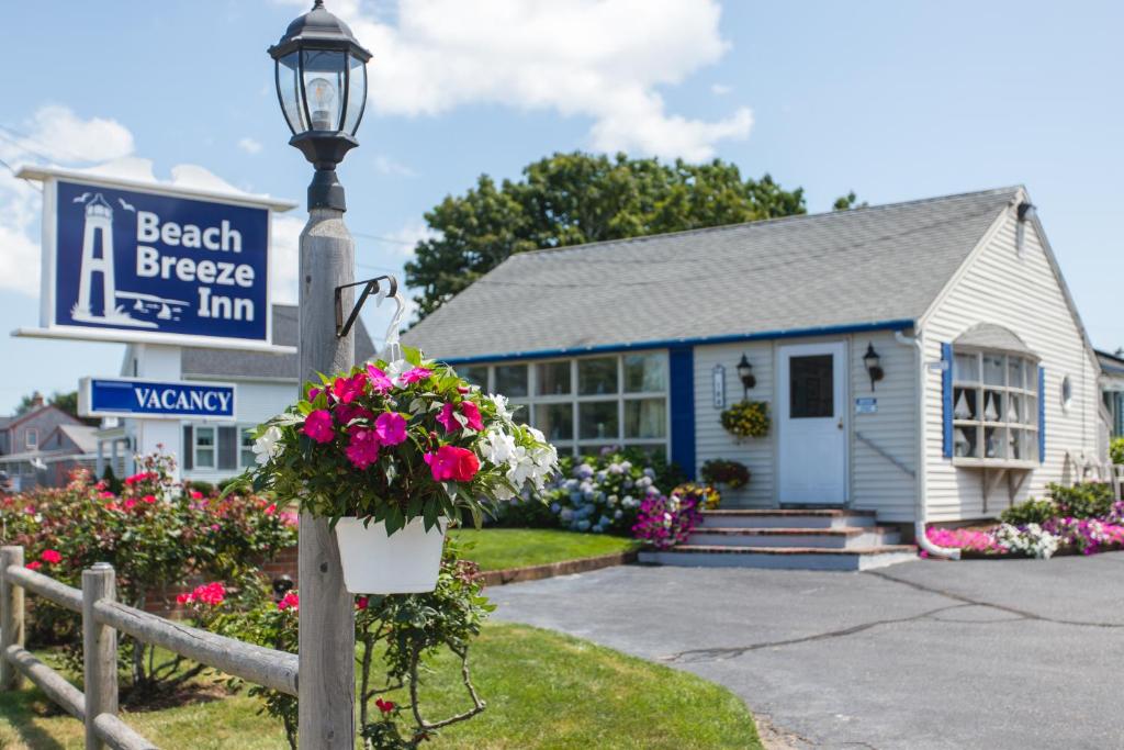 a beach breeze inn with flowers in front of it at A Beach Breeze Inn in West Harwich