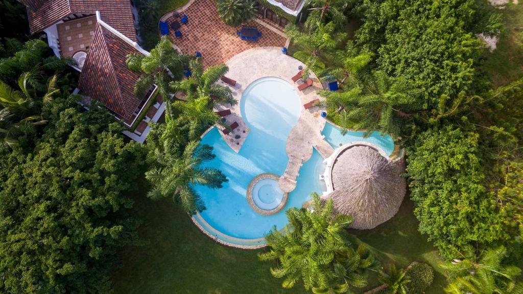 an overhead view of a swimming pool with trees at Casa de Campo Luxury Villas - Private Paradise at La Romana in La Romana