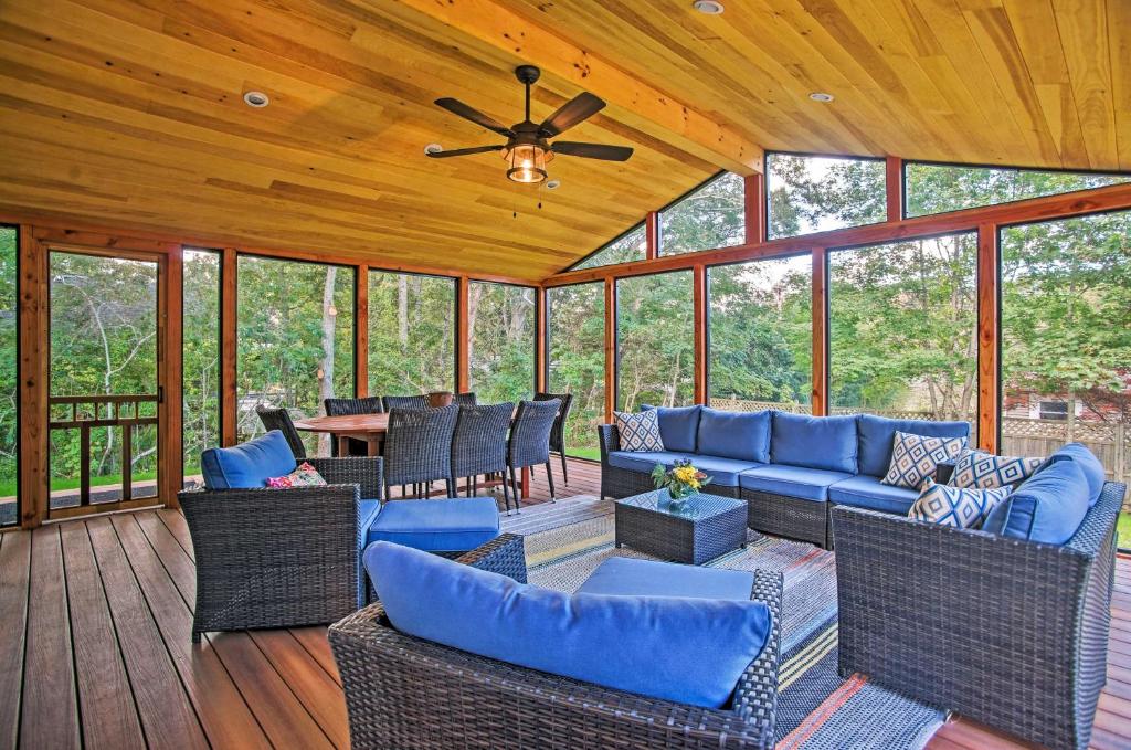 a screened in porch with furniture and a ceiling fan at Family-Friendly Tisbury Escape - Walk to Town in Vineyard Haven