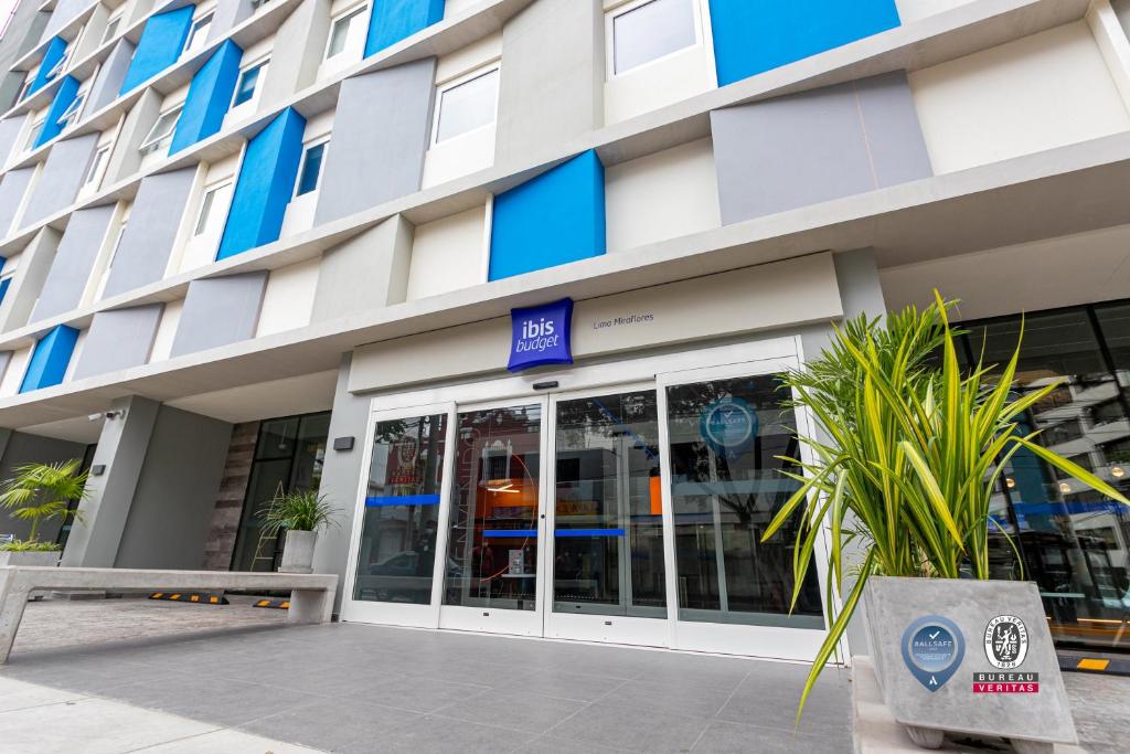 a facade of a building with glass doors at ibis budget Lima Miraflores in Lima