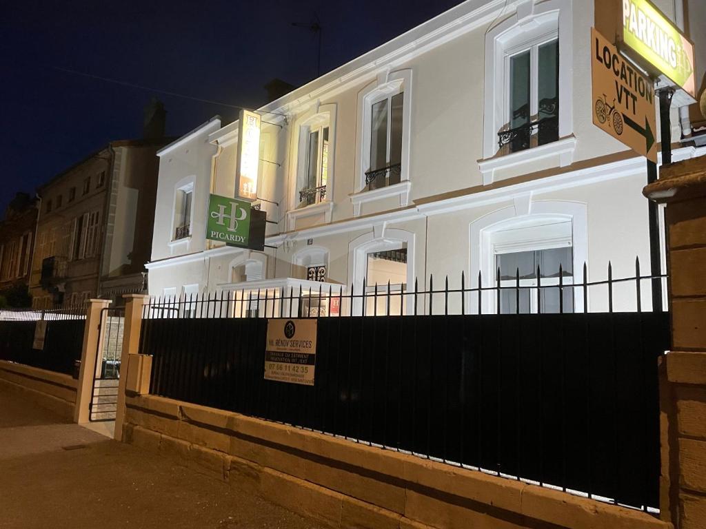 a white building on a street at night at Hôtel Le Picardy in Saint-Dizier