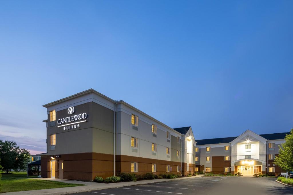 a large building with a clock on the front of it at Candlewood Suites Windsor Locks, an IHG Hotel in Windsor Locks
