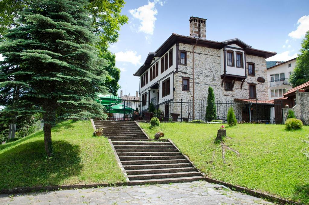 an old house with stairs in front of it at Petko Takov's House in Smolyan