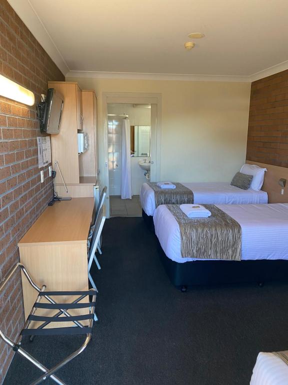 Postel nebo postele na pokoji v ubytování Maitland City Motel