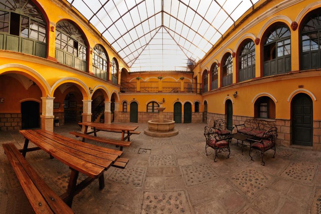 a large building with benches and a fountain in it at Casona Potosi in Potosí